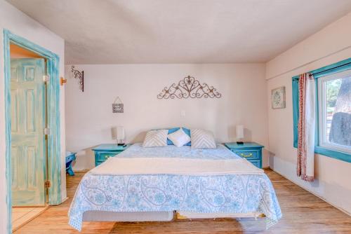 a bedroom with a bed and two blue cabinets at Enchanted Hideaway Cabins and Cottages in Ruidoso