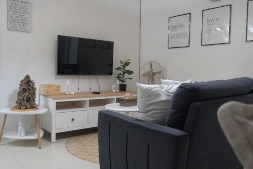 a living room with a couch and a tv at Johns Place one bedroom in Olongapo