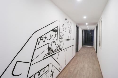 a hallway with a drawing on the wall at Townhouse Noida Sector 71 Near ISKCON Temple Noida in Indirapuram