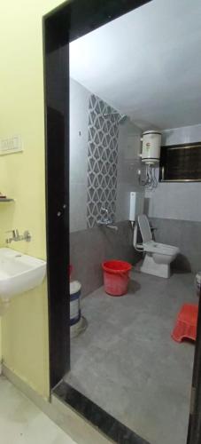 a bathroom with a sink and a toilet at Mallikarjun Residency with AC in Akalkot