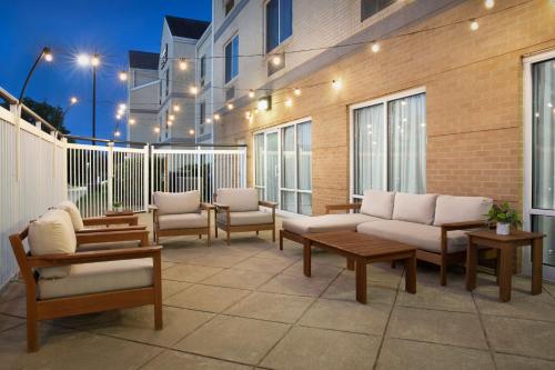 a patio with couches and chairs on a building at Fairfield Inn & Suites Dulles Airport in Sterling