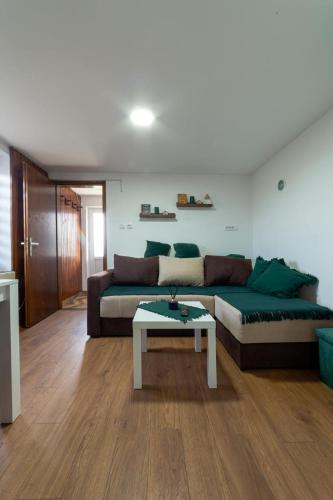 a living room with a couch and a coffee table at Apartmani LUFT in Bajina Bašta