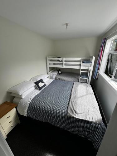 a small bedroom with a bed and a window at Ocean Breeze Retreat in Kaka Point