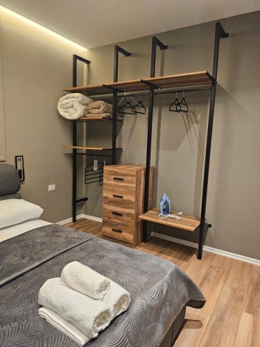 a bedroom with a bunk bed and a wooden dresser at Tirana Apartment KDK in Tirana