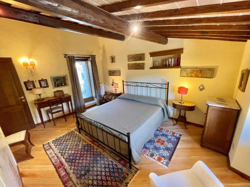 a bedroom with a bed and a table in a room at Luxurious Umbrian Retreat for 10 with Private Terrace and Pool in Torrecola