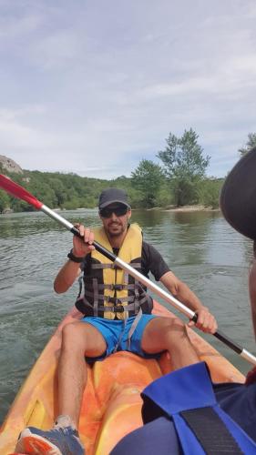a man in a kayak on a river at Aux berges du pont du gard in Vers Pont du Gard