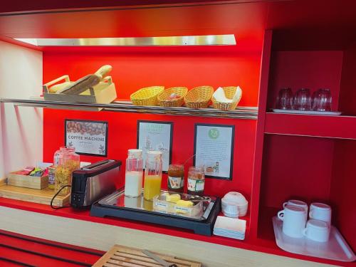 a counter with some food on a red wall at HôtelF1 Angoulême in Champniers