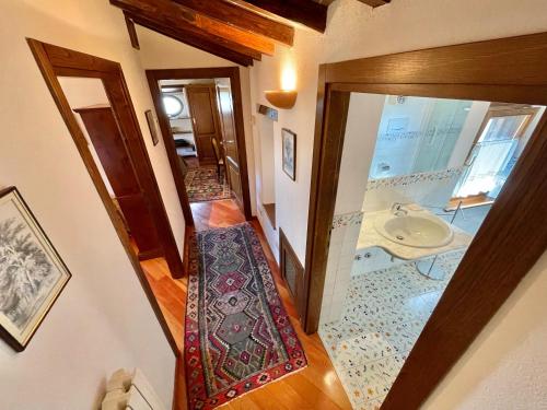 a hallway with a bathroom with a sink at Luxurious Umbrian Retreat for 10 with Private Terrace and Pool in Torrecola