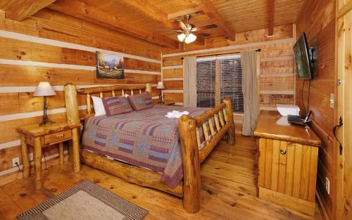 a bedroom with a bed in a log cabin at Highland Hideaway in Gatlinburg