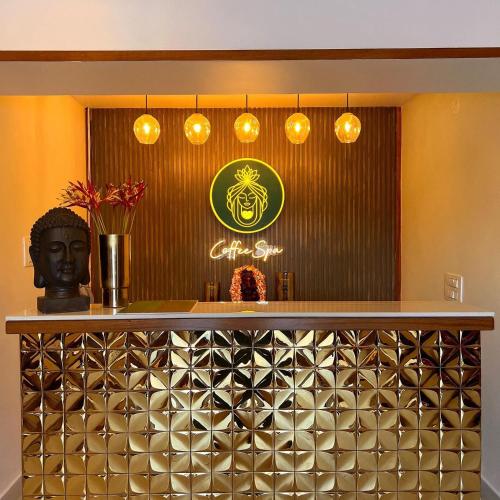 a restaurant with a counter with lights on it at Mayur Belgaum Presidency Hotel & Spa in Belgaum