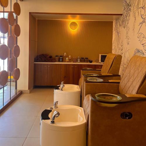 a bathroom with two sinks and a sink at Mayur Belgaum Presidency Hotel & Spa in Belgaum