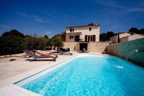 une piscine avec deux chaises et une maison dans l'établissement La Petite Colline, à Apt