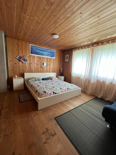 a bedroom with a bed and a wooden ceiling at la porrettaz d'en haut in Provence