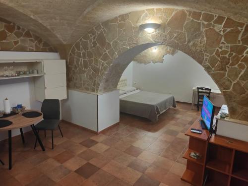a room with a bed and a table with a desk at Casa Vacanza De Flagilla in Brindisi