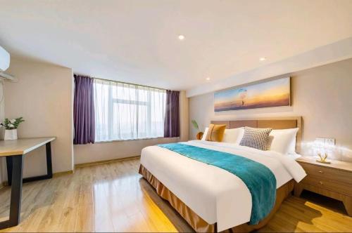 Postel nebo postele na pokoji v ubytování Zizaiju Serviced Apartment