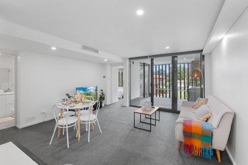 a living room with a couch and a table at Apt Near Garden City&3km to QSAC in Brisbane