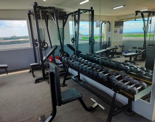 a gym with lots of equipment in a room at La grande Hotel & Residence in Angeles