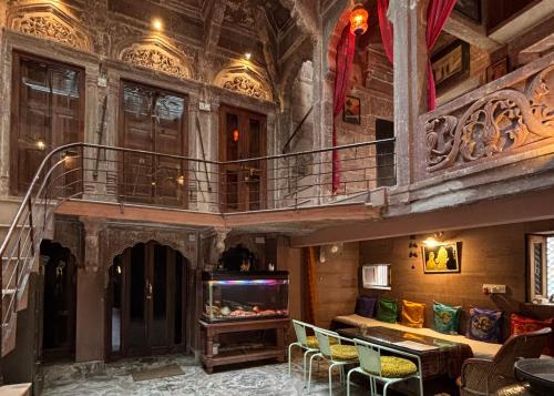 a large room with a balcony and a fish tank at Shahi Guest House in Jodhpur