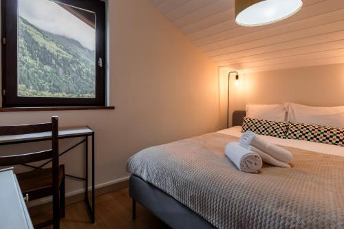 une petite chambre avec un lit avec des serviettes dessus dans l'établissement Les Chamois - Duplex - Vue magnifique, à Chamonix-Mont-Blanc