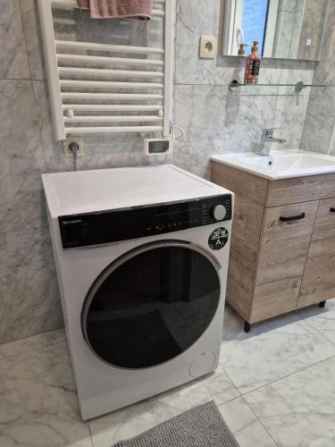 a microwave in a bathroom with a sink at Tasson Snel apartment center of Brussels in Brussels