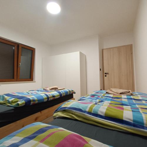 a room with two beds and a cabinet in it at Apartman Nona in Motovun