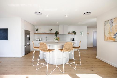 a kitchen and dining room with a table and chairs at The Shores Surfers Paradise Apartments in Gold Coast