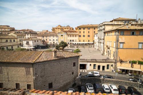 a city with cars parked in a parking lot at Casa Mura in Bracciano