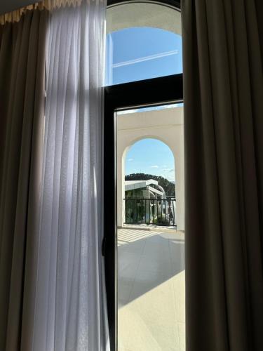 an open window with a view of a building at Hotel Panorama & Spa Elbasan in Elbasan