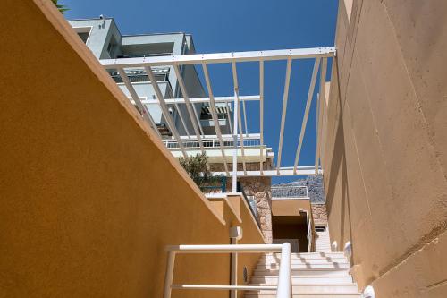 a group of stairs with a building in the background at Apartments Villa Loznica in Brela