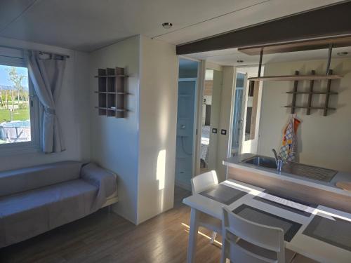 a living room with a table and a couch at Agricampeggio AL CIELO STELLATO in Valeggio sul Mincio