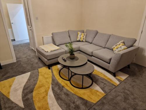 a living room with a couch and a table at Catalina - Modern 2 bedroom bungalow in Elgin