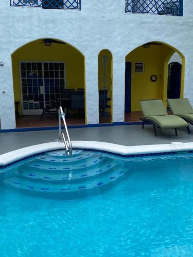 a swimming pool with a water fountain in the middle at Villa Hanna in Bon Accord