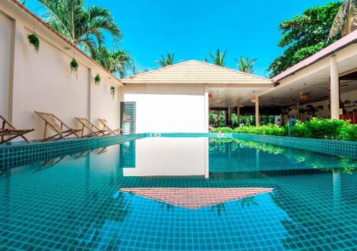 a swimming pool at a resort with a white board in it at Sunlight Bungalow in Phu Quoc
