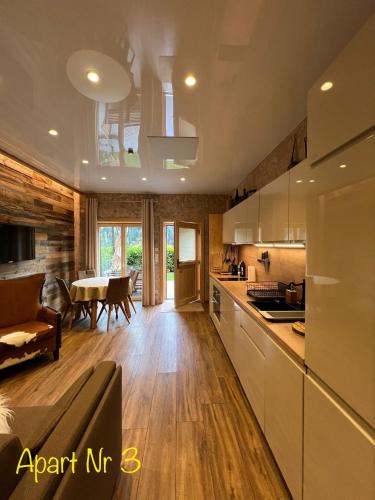 a kitchen and dining room with a dining table at Alpenburg Bergparadies Apartments in Wald am Arlberg