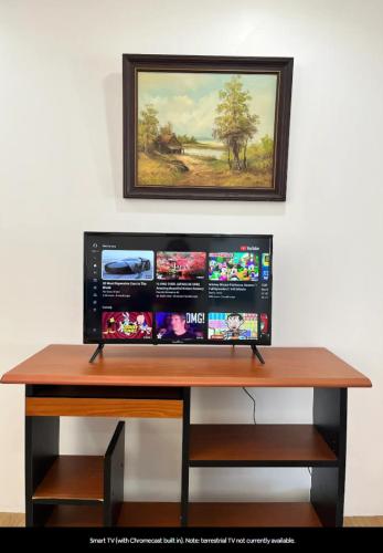 a desk with a computer monitor on top of it at Private guest suite near the airport 1-4 guests in Auckland