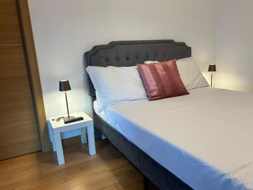a bedroom with a bed and a side table at Dina Suite Rome in Rome