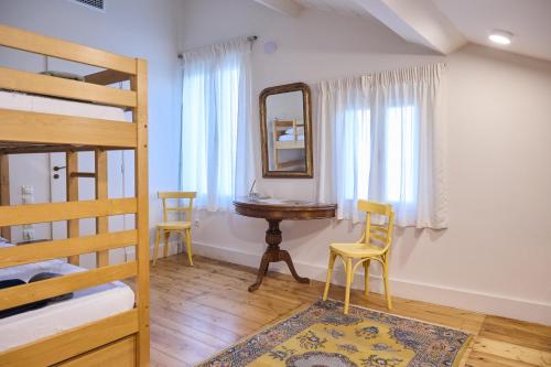 a bedroom with a desk and a mirror and a bed at 1906 Citygarden in Chios