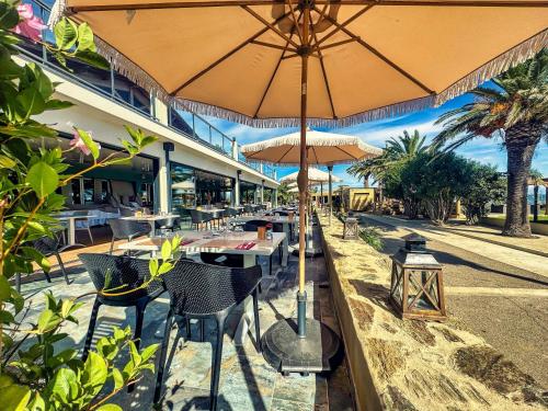 a restaurant with tables and chairs with umbrellas at Hotel & Restaurant San Pellegrino in Folelli