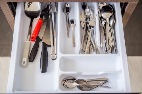 a white drawer filled with utensils at come home pool villa cha-am in Phetchaburi