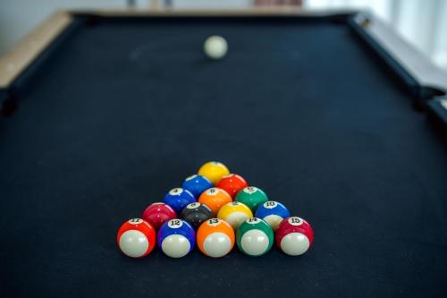 a group of billiard balls on a pool table at come home pool villa cha-am in Phetchaburi