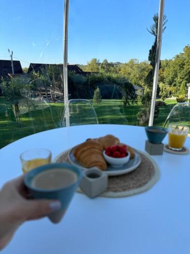 a person holding a plate of food on a table at VALEA MAGURII in Novaci