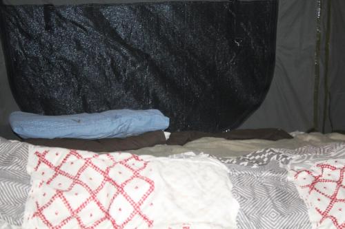 a bed with a blanket and two pillows on it at Isikhoma-Khoma in Hilton