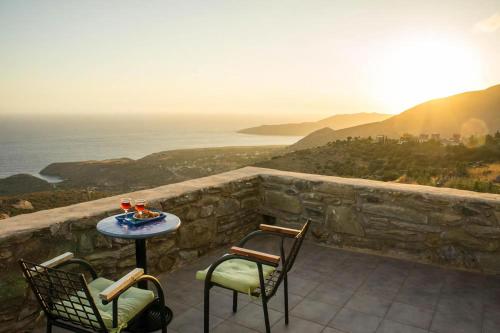 a patio with a table and chairs and the ocean at Benos Tower in Tsikkaliá
