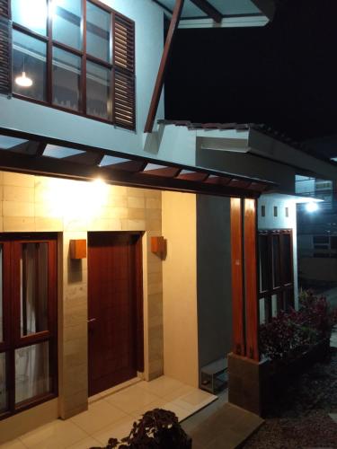 a house with a door in the middle at Villa Viva Mezzanine - Family in Lembang