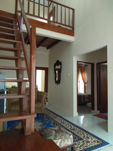 a living room with a spiral staircase in a house at Villa Viva Mezzanine - Family in Lembang