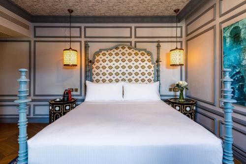 a bedroom with a large bed with two night stands at Hagia Sofia Mansions Istanbul, Curio Collection by Hilton in Istanbul