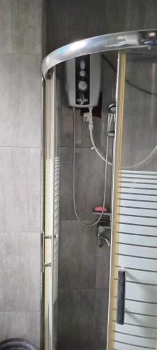 a shower in a bathroom with a glass door at Rohan's Residence in Kandana