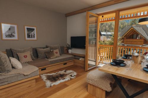 a living room with a couch and a table at Goldhorn Chalet SKI IN&OUT in Kranjska Gora