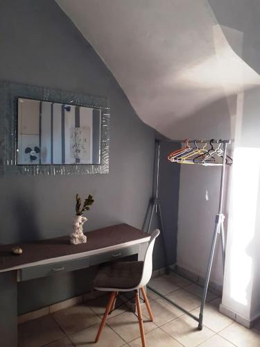 a room with a desk and a lamp and a mirror at Erofili Apartment in Kalyves