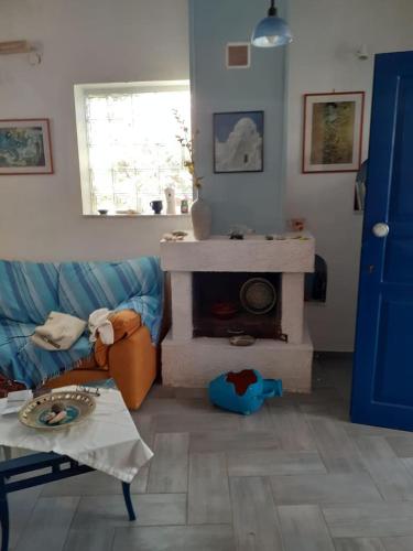 a living room with a couch and a fireplace at Erofili Apartment in Kalyves